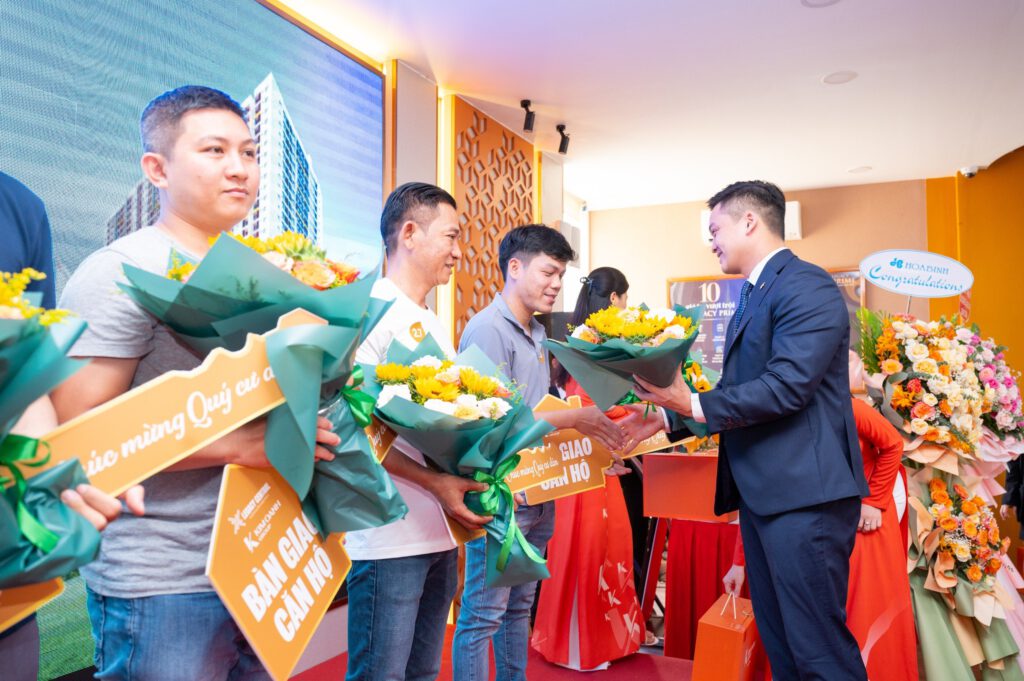 Ông Lê Viết Hiếu trao bó hoa tươi thắm chúc mừng cư dân Legacy Central chính thức nhận bàn giao căn hộ